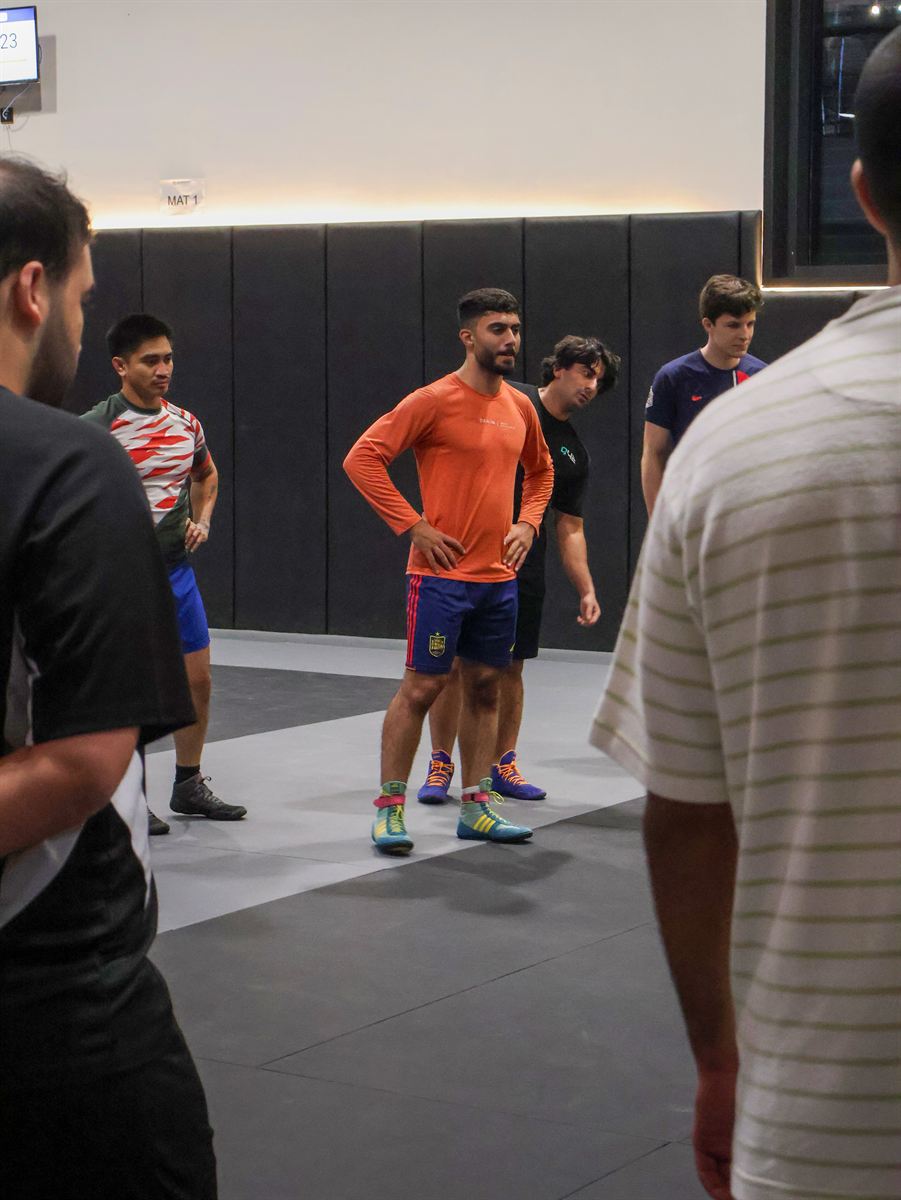 Athletes watching a technique being broken down between rounds