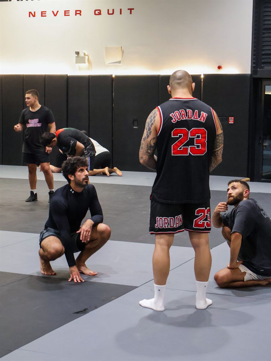 A coach walking the room while the class drills