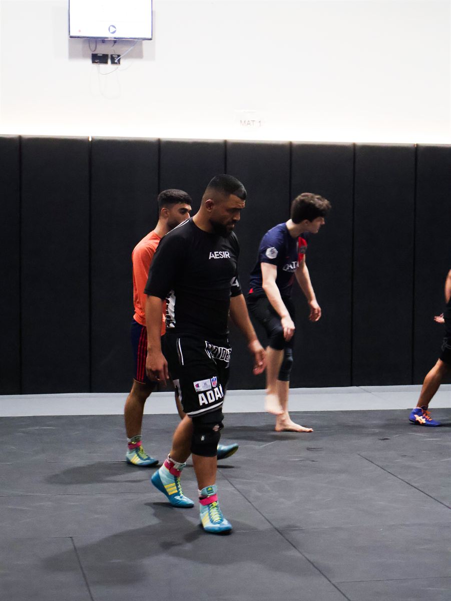 Athletes crossing the mat between rounds