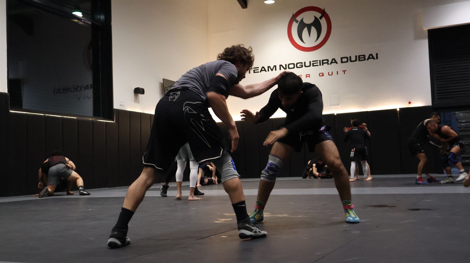 Two grapplers breaking stance during open mat at Team Nogueira Dubai